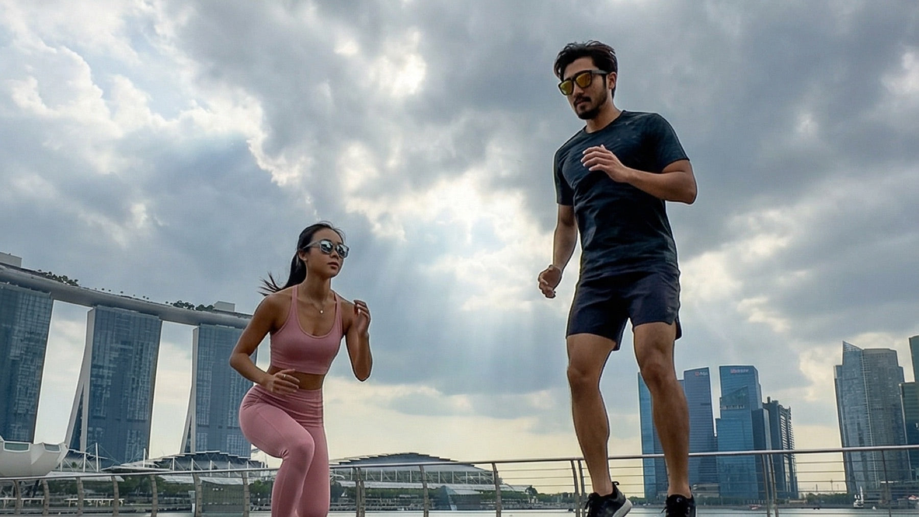 Two outdoor runners in Singapore wearing 2nu sunglasses, showing different frame fits for active urban use