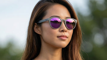 Woman wearing 2nu sunglasses with vibrant reflective lenses outdoors, showing lens colour and screen-readability considerations