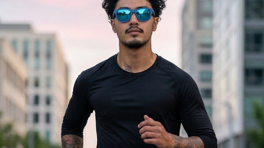 Runner wearing outdoor performance sunglasses on an urban route under a bright cloudy sky