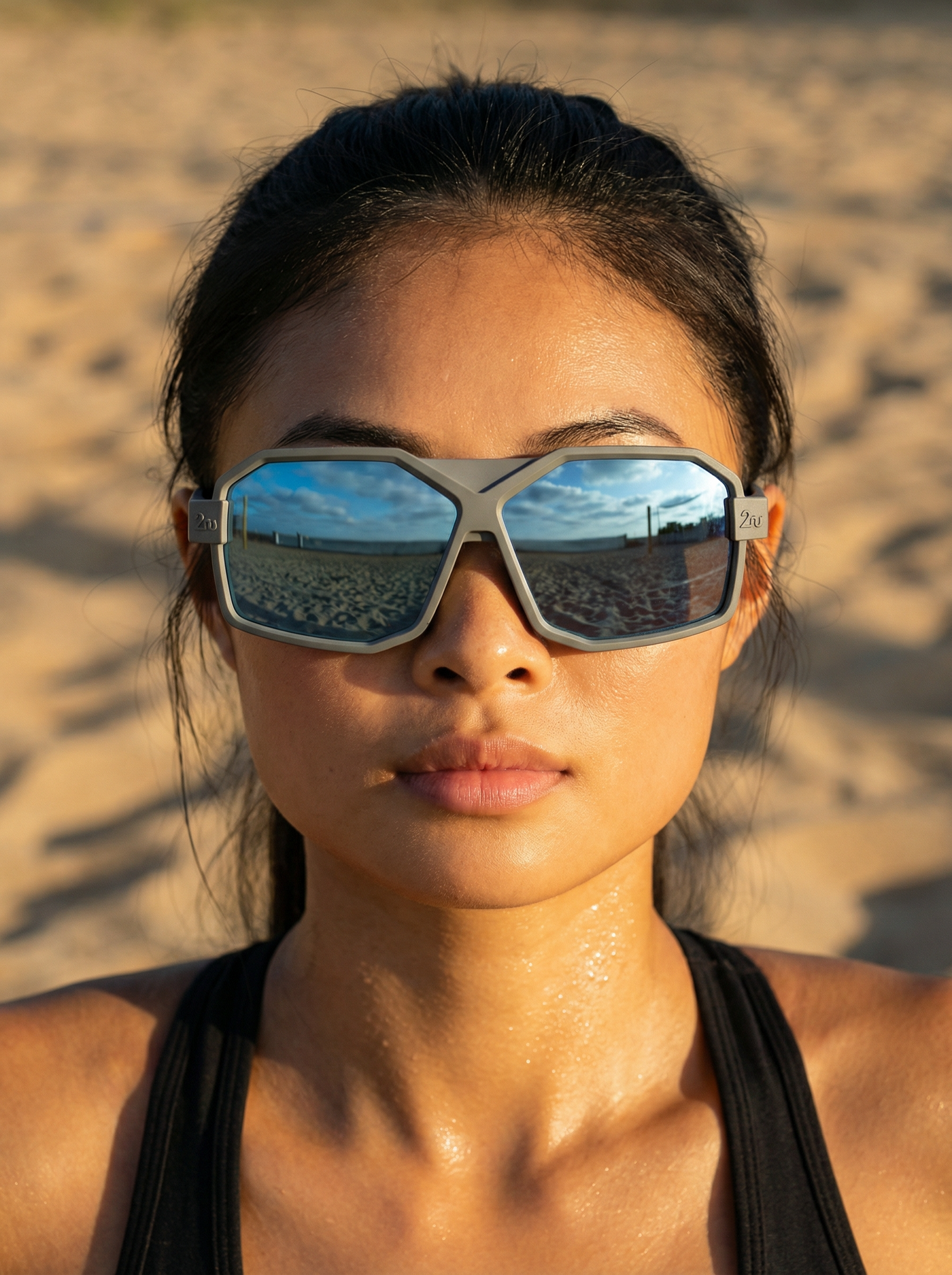 Person wearing 2nu sunglasses on a beach with reflective lenses