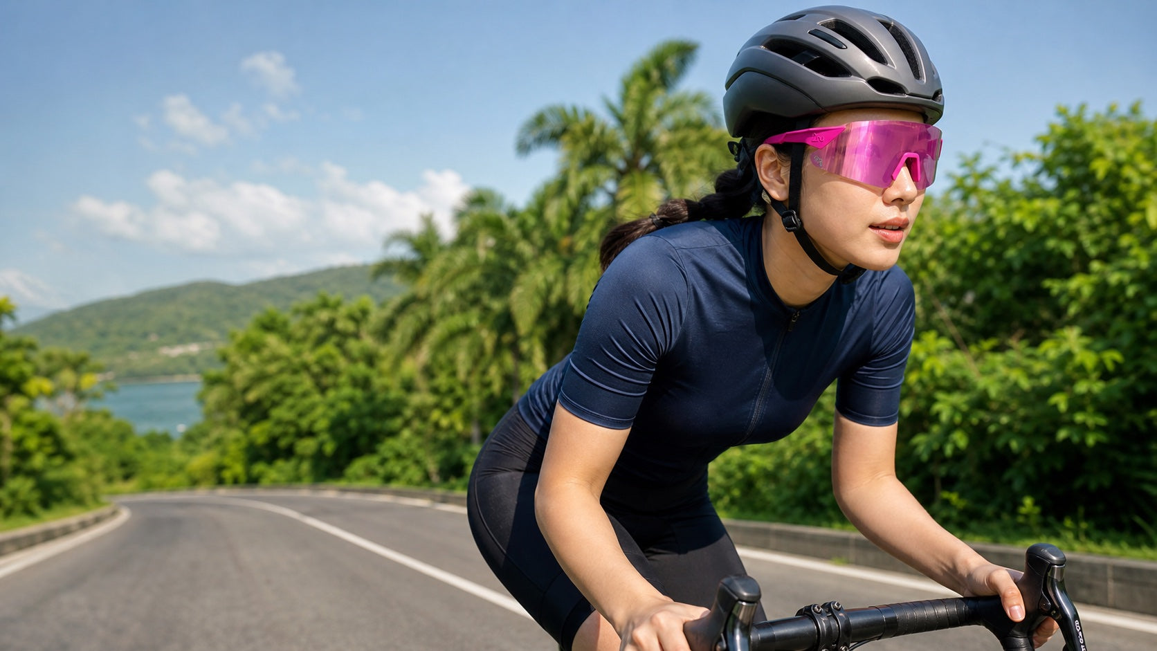 Cyclist wearing pink 2nu Venti Air sunglasses on an open road for the Fishing and Cycling sunglasses guide.